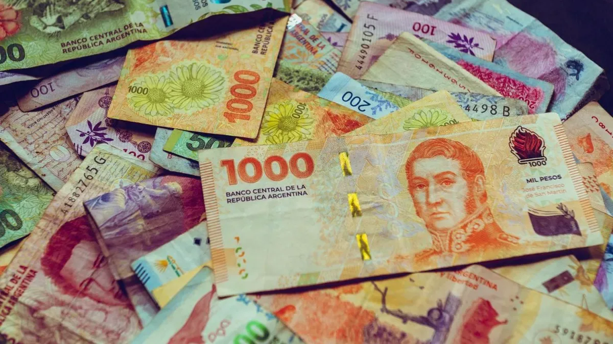 Empleado revisando beneficios corporativos en su celular en una oficina argentina