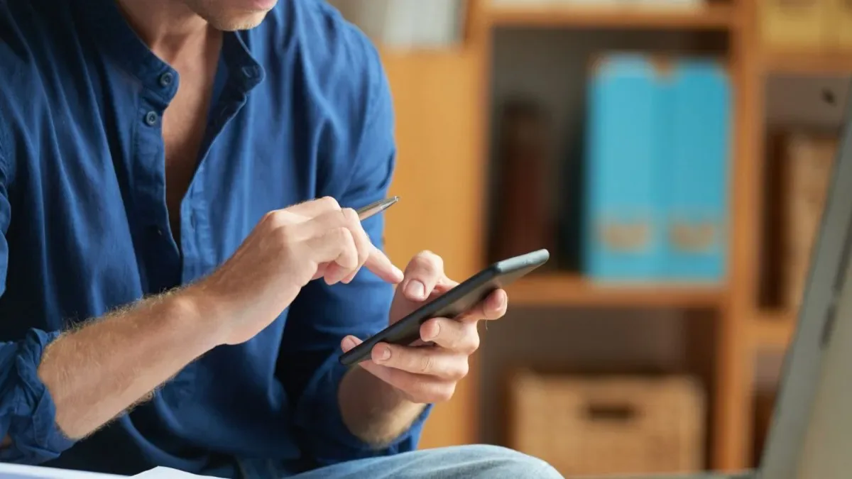 Dispositivo físico bloqueador de celular sobre escritorio minimalista con teléfono apagado